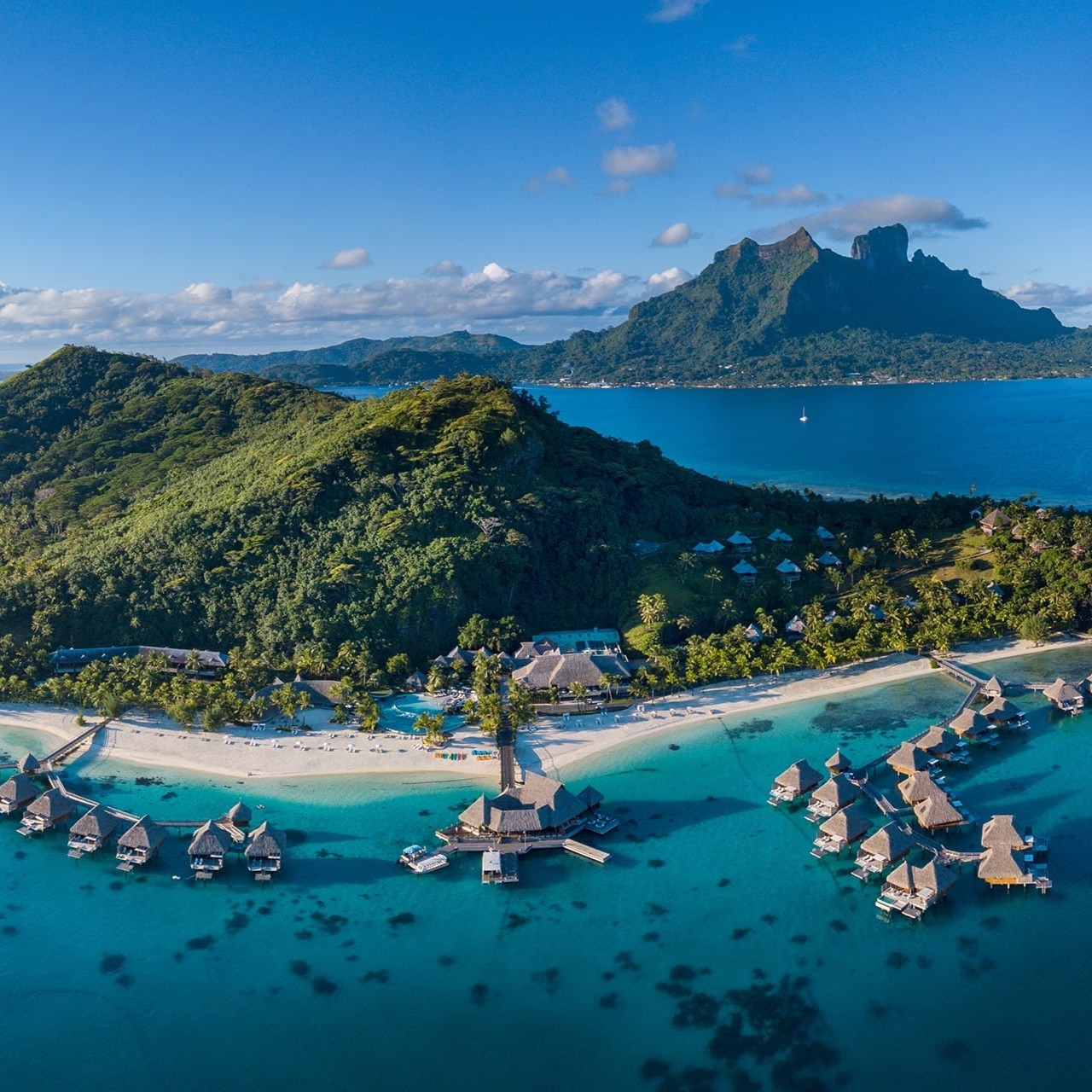 Luxury overwater bungalows above turquoise water